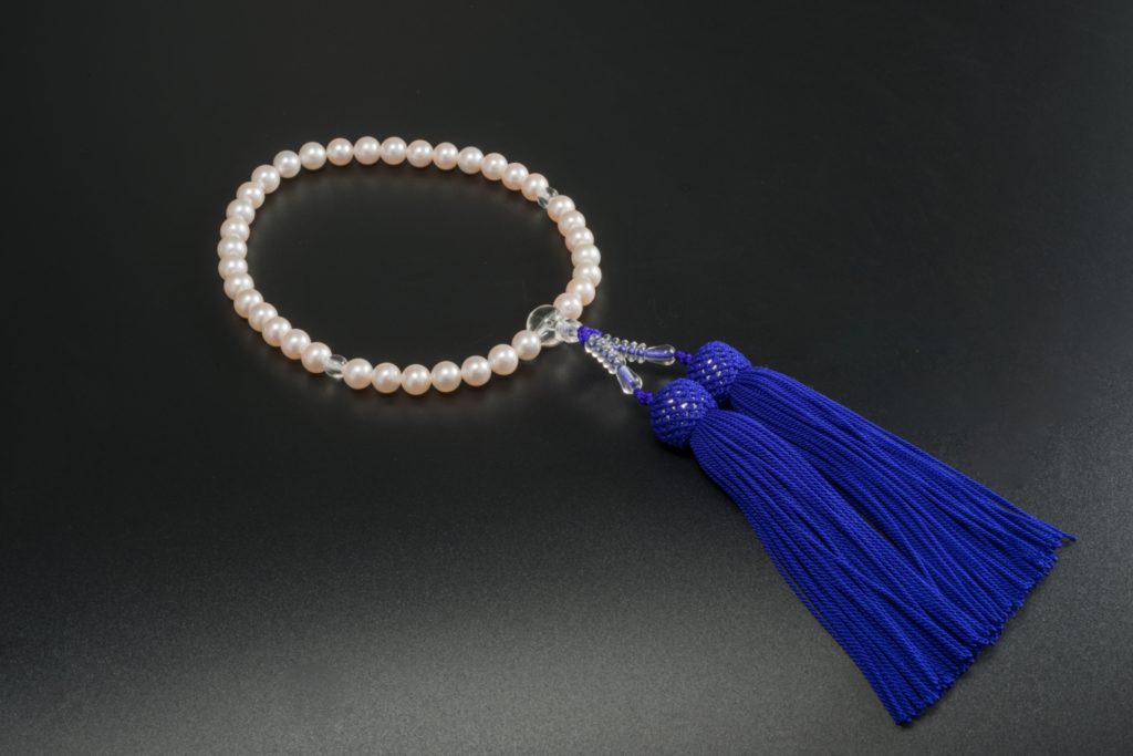白い真珠の珠で青い房の略式念珠